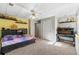 This cozy bedroom features a ceiling fan, built-in shelves and an adjacent desk area at 5652 Harbormist Dr, Powder Springs, GA 30127