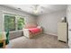 Bedroom boasts a light wood-framed bed with storage drawers and a large window for ample natural light at 5652 Harbormist Dr, Powder Springs, GA 30127
