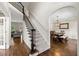 Inviting foyer with hardwood floors, staircase, and an arched entrance to the dining room at 5652 Harbormist Dr, Powder Springs, GA 30127