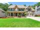 Charming two-story home with a well-manicured lawn, covered porch, and attached two-car garage at 5652 Harbormist Dr, Powder Springs, GA 30127