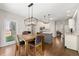 Spacious kitchen area with a central island, stainless steel appliances, and stylish pendant lighting at 5652 Harbormist Dr, Powder Springs, GA 30127