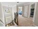 Upper landing with view to foyer below and bedroom hallway with open door at 5652 Harbormist Dr, Powder Springs, GA 30127
