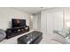 This living room has a sofa, a television and carpeted floors at 5652 Harbormist Dr, Powder Springs, GA 30127