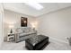 This living room has a sofa, ottoman, and carpeted floors at 5652 Harbormist Dr, Powder Springs, GA 30127