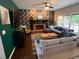 Bright living room with a fireplace, comfortable seating, a TV, and natural light from surrounding windows at 5652 Harbormist Dr, Powder Springs, GA 30127