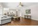 Open living room with hardwood floors, a comfortable gray sofa, and open doorway to kitchen at 5652 Harbormist Dr, Powder Springs, GA 30127