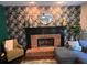 Inviting living room featuring a brick fireplace, a decorative wall, and comfortable seating area at 5652 Harbormist Dr, Powder Springs, GA 30127