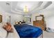 Spacious main bedroom with tray ceiling, dresser, and ensuite bathroom entrance at 5652 Harbormist Dr, Powder Springs, GA 30127