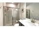 Bathroom with a glass enclosed shower, gray tile surround, and chrome shower fixtures at 1835 Wellston Dr, Lawrenceville, GA 30043