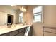 Bright bathroom featuring double sinks, vanity lighting, and a large mirror at 1835 Wellston Dr, Lawrenceville, GA 30043