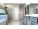Bright bathroom with a double-sink vanity, glass-enclosed shower, and a separate soaking tub at 1835 Wellston Dr, Lawrenceville, GA 30043