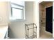 Bathroom featuring a window, vanity, and a view into the shower and tub area at 1835 Wellston Dr, Lawrenceville, GA 30043