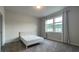Bright bedroom featuring neutral carpets, a bed and a large bright window at 1835 Wellston Dr, Lawrenceville, GA 30043
