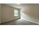 Cozy bedroom with neutral walls, soft carpeting, and a window offering natural light at 1835 Wellston Dr, Lawrenceville, GA 30043