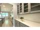 Butler's pantry featuring ample counter space, cabinets and glass shelving to the side of the kitchen at 1835 Wellston Dr, Lawrenceville, GA 30043