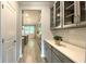 Butler's pantry with ample counter space, cabinets, and glass shelving to the side of the kitchen at 1835 Wellston Dr, Lawrenceville, GA 30043