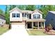 Beautiful two-story home with a combination of brick and siding, landscaped yard and a two car garage at 1835 Wellston Dr, Lawrenceville, GA 30043