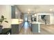 Open concept kitchen with a large island, modern appliances, hard wood floors and access to staircase at 1835 Wellston Dr, Lawrenceville, GA 30043
