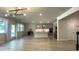 Spacious living area with hardwood floors, modern lighting, and large windows allowing for abundant natural light at 1835 Wellston Dr, Lawrenceville, GA 30043