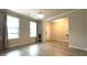 Bright living room featuring hardwood floors, modern lighting, and open access to the entryway at 1835 Wellston Dr, Lawrenceville, GA 30043