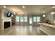 Open-concept living room with hardwood floors, natural light, fireplace and access to the kitchen at 1835 Wellston Dr, Lawrenceville, GA 30043