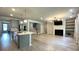 Bright open floor plan featuring a modern kitchen with stainless appliances and a cozy fireplace at 1835 Wellston Dr, Lawrenceville, GA 30043