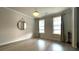 Bright living room featuring hardwood floors, modern lighting, and windows with curtains at 1835 Wellston Dr, Lawrenceville, GA 30043