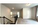 Spacious loft area with staircase, plush carpeting, and views to other rooms at 1835 Wellston Dr, Lawrenceville, GA 30043