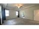 Large main bedroom with tray ceiling, neutral paint, and an ensuite bathroom at 1835 Wellston Dr, Lawrenceville, GA 30043