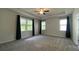 Spacious primary bedroom featuring tray ceilings, a ceiling fan, and plenty of natural light at 1835 Wellston Dr, Lawrenceville, GA 30043