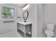Updated bathroom with modern fixtures, sleek vanity, geometric mirror, and a toilet at 2506 Octavia Ln, Marietta, GA 30062