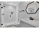 Modern bathroom featuring a glass shower with tiled walls and a sleek vanity with a geometric mirror at 2506 Octavia Ln, Marietta, GA 30062
