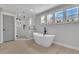 Bright bathroom featuring a modern soaking tub and a glass-enclosed shower with elegant fixtures and natural light at 2506 Octavia Ln, Marietta, GA 30062