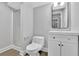 Bathroom featuring a vanity with modern fixtures, a toilet, and a tiled shower with a glass door at 2506 Octavia Ln, Marietta, GA 30062