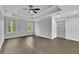 Open bedroom with hardwood floors, high tray ceilings, bright windows, and a closet door at 2506 Octavia Ln, Marietta, GA 30062