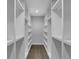 Spacious walk-in closet with custom white shelving, providing ample storage and organization space at 2506 Octavia Ln, Marietta, GA 30062