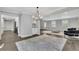 Spacious living room with hardwood floors, modern lighting, and views of the kitchen at 2506 Octavia Ln, Marietta, GA 30062