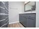 Stylish bathroom features a vanity with gray cabinets, quartz countertop and chrome fixtures at 325 Berry Ct, Villa Rica, GA 30180