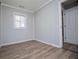 Bedroom featuring wood-look flooring, gray paint, and a bright window at 325 Berry Ct, Villa Rica, GA 30180