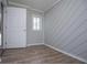 A bedroom showcasing gray wood-look flooring, modern paint, and natural light at 325 Berry Ct, Villa Rica, GA 30180
