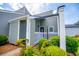 Home exterior featuring light-green siding, white trim, and meticulously maintained landscaping at 325 Berry Ct, Villa Rica, GA 30180