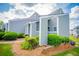 Quaint home exterior with manicured bushes and light-green siding on a sunny day at 325 Berry Ct, Villa Rica, GA 30180