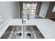 The kitchen features a stainless steel sink with modern faucet and a view of the outdoor balcony at 325 Berry Ct, Villa Rica, GA 30180