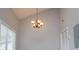 Living room showcasing a vaulted ceiling, a stylish chandelier, and a window for natural light at 325 Berry Ct, Villa Rica, GA 30180