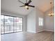 Bright living room featuring a ceiling fan, sliding glass doors to a balcony, and wood-look flooring at 325 Berry Ct, Villa Rica, GA 30180