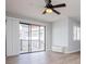 Bright living room with wood floors, ceiling fan, and sliding glass door leading to balcony at 325 Berry Ct, Villa Rica, GA 30180