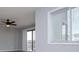 Bright living room featuring a ceiling fan, sliding glass doors to a balcony, and a window at 325 Berry Ct, Villa Rica, GA 30180