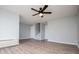 Inviting living room featuring wood floors, ceiling fan, light gray paint, and multiple entry ways at 325 Berry Ct, Villa Rica, GA 30180