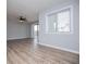 A living room featuring wood-look flooring, a ceiling fan, a window, and sliding glass doors to a balcony at 325 Berry Ct, Villa Rica, GA 30180