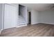 Spacious living room with new light gray paint, wood floors, and a staircase and closet at 325 Berry Ct, Villa Rica, GA 30180
